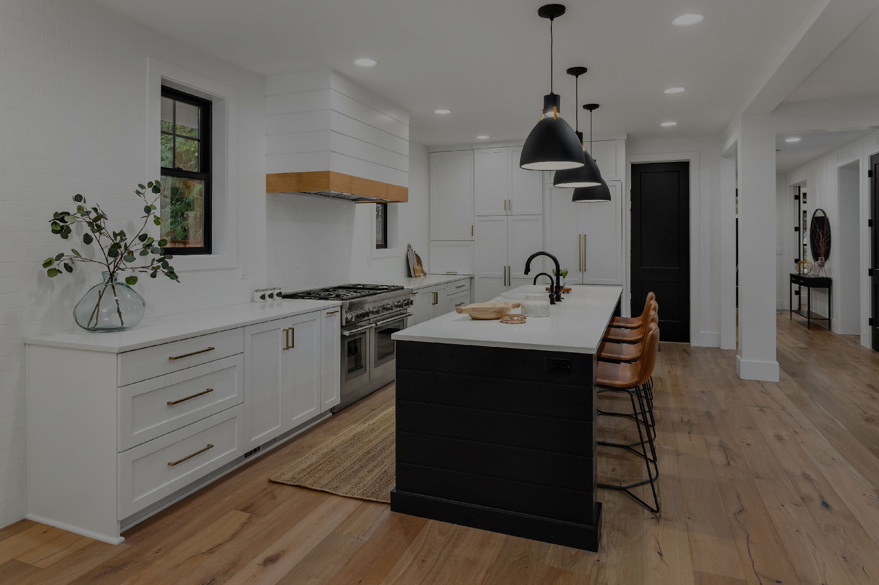 Beautiful white kitchen with dark accents in new modern farmhouse style luxury home1